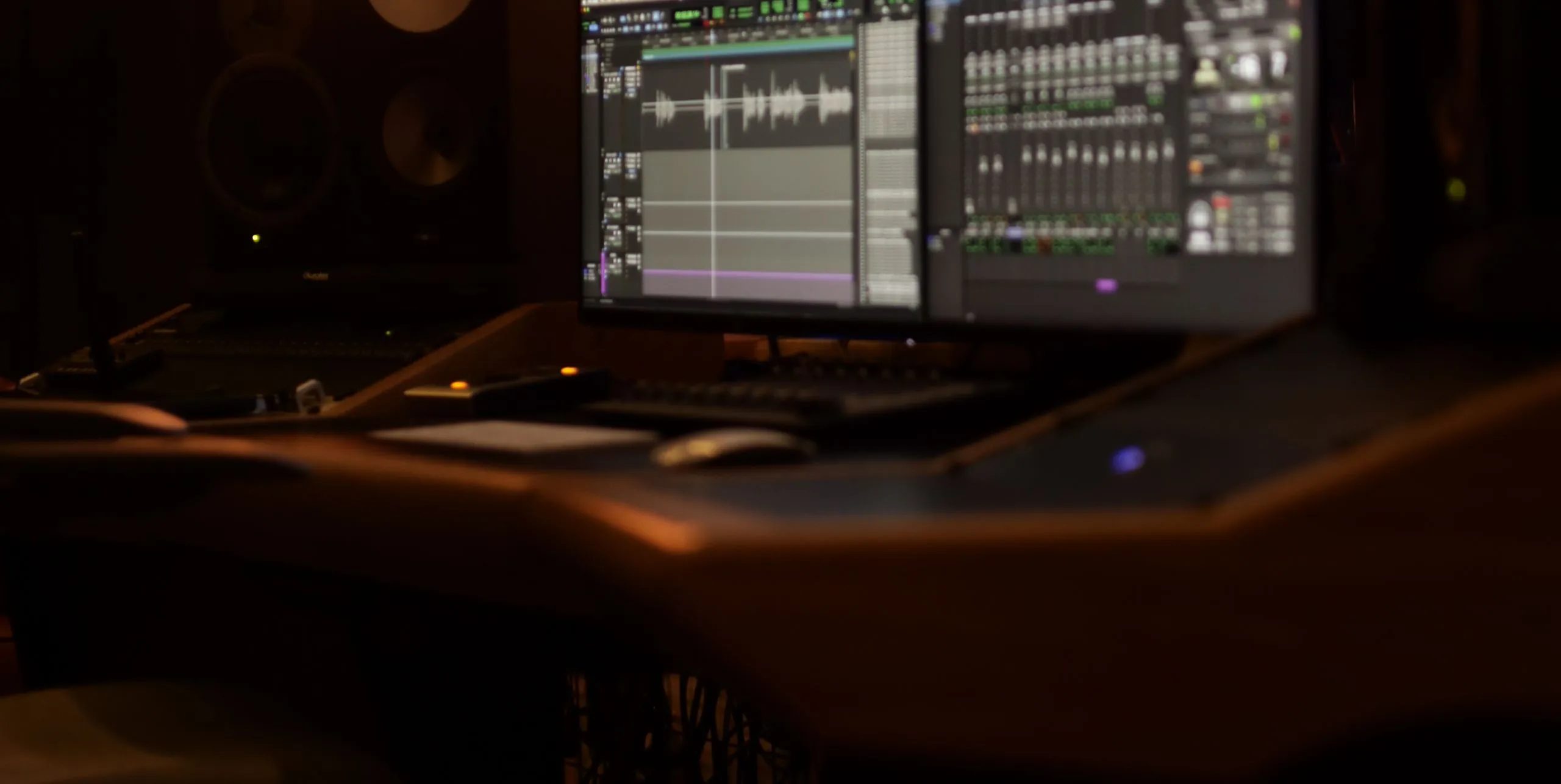 Mike Jaballah's edit studio in dim light with a Pro Tools session on screen