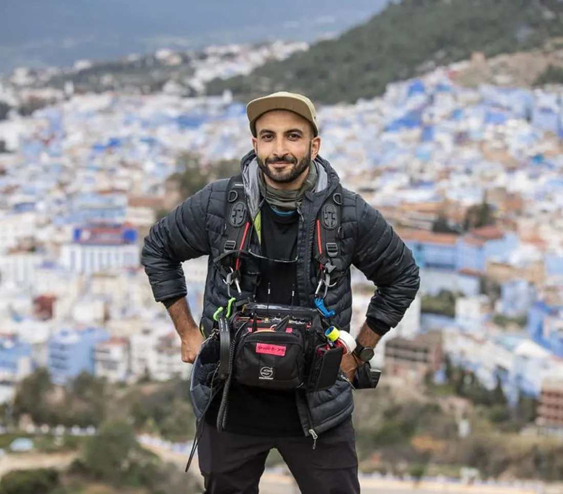 Mike Jaballah wearing his sound bag in a blue washed town in Morocco