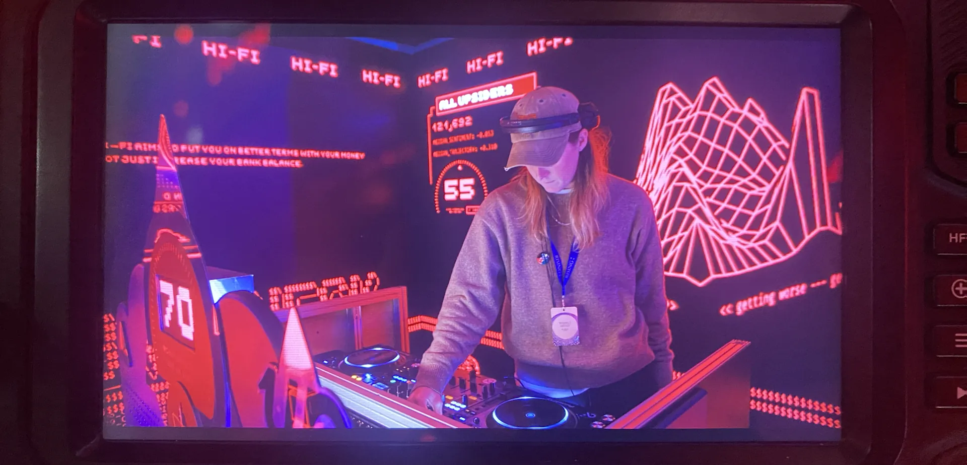 DJ playing in a red DJ booth at the Up Bank Rising Fest night trade event