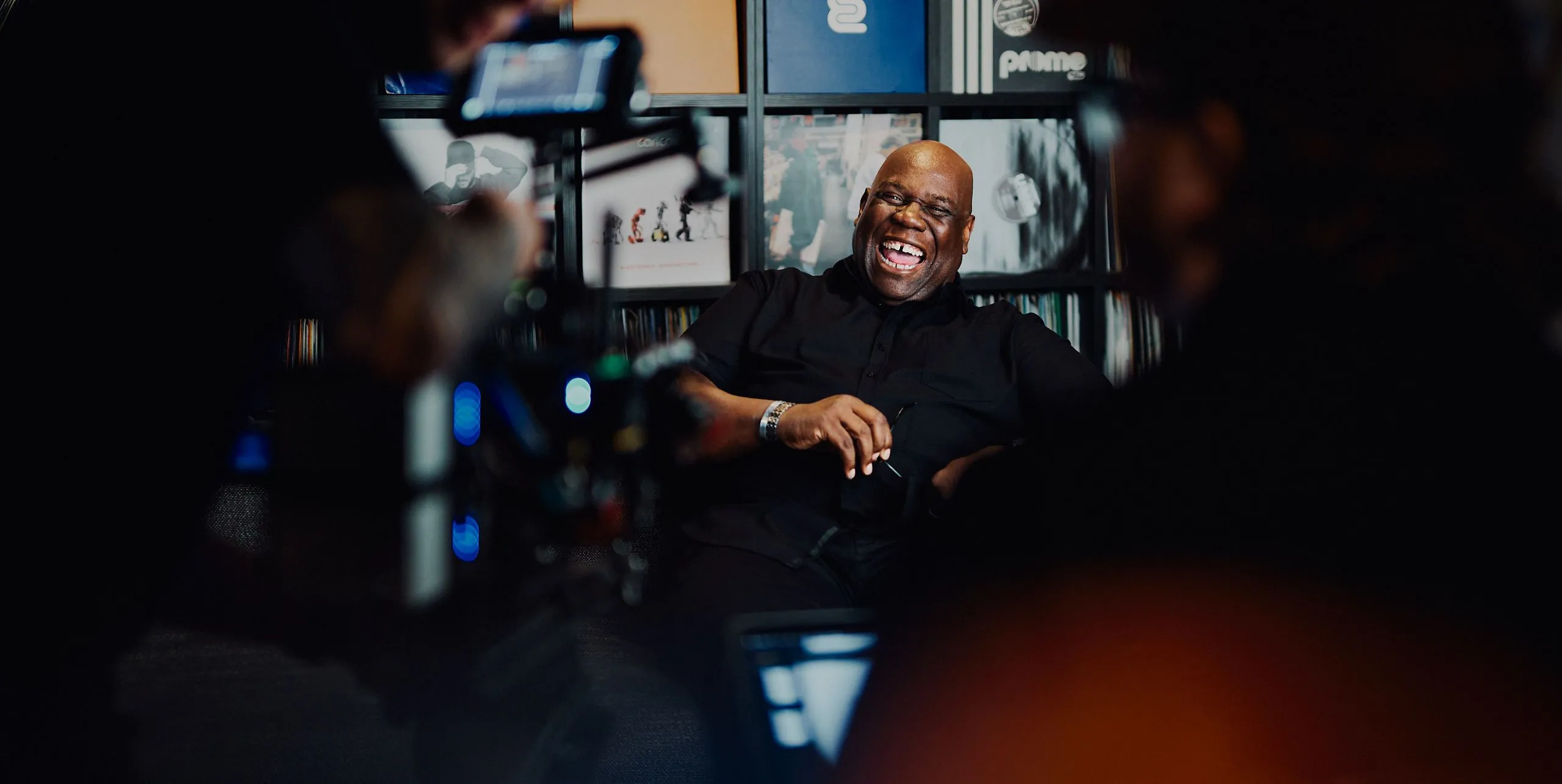 Carl Cox laughing on set with the camera crew in the foreground, filming the Universe launch video
