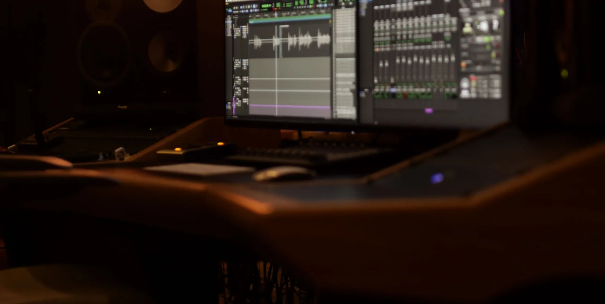 Mike Jaballah's edit studio in dim light with a Pro Tools session on screen